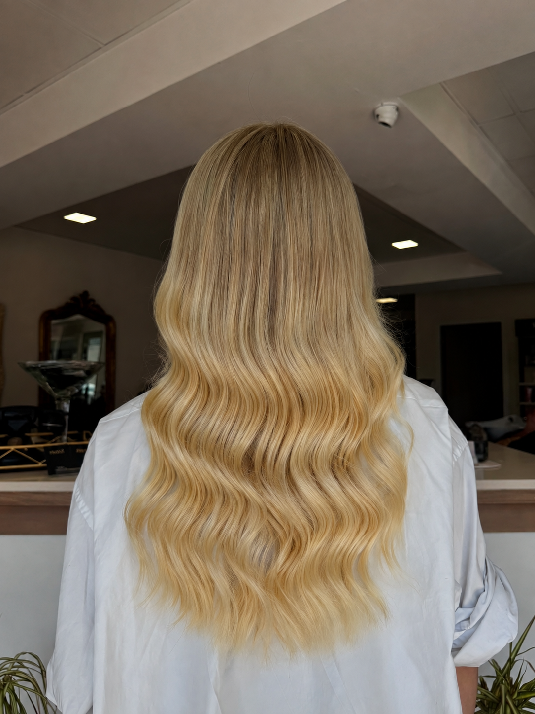 Beige blonde balayage with long soft waves and extensions