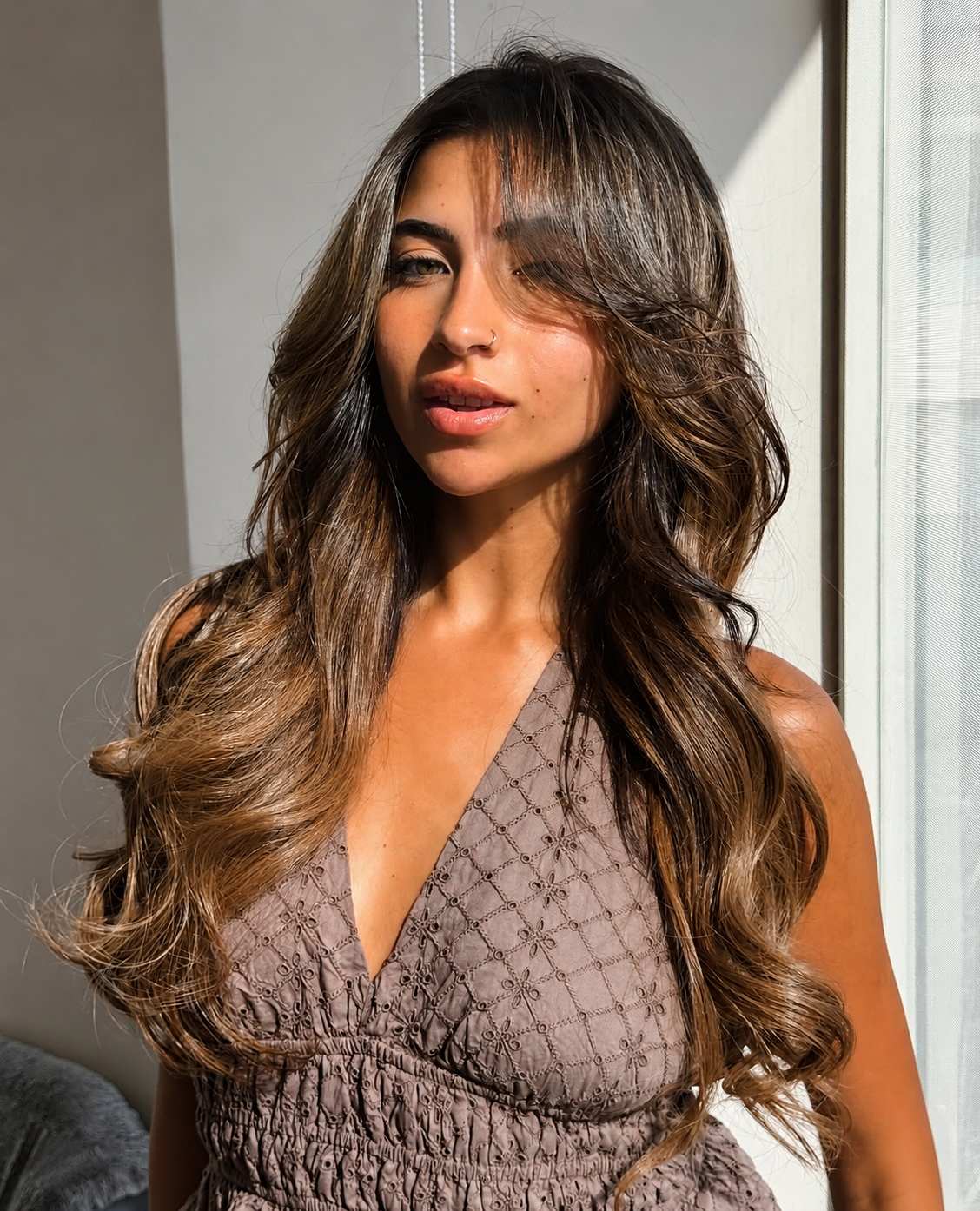 Long brunette hair with balayage highlights and soft waves